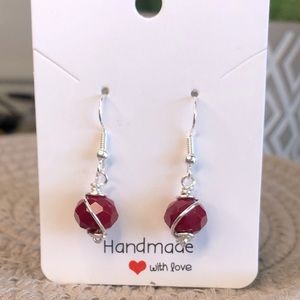 Hand wrapped earrings with red glass beads